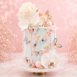 Decorative cake with flowers and butterflies on a pink background