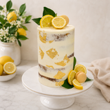 Lemon cake with decorative elements on a white marble surface