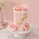 Pink cake with floral decorations on a marble surface