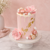 Pink cake with floral decorations on a marble surface